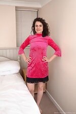 Sabrina Eve models her pink dress in bed